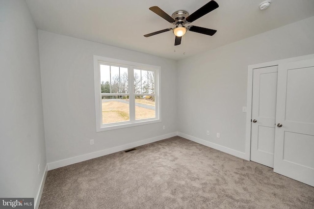 interior space with light colored carpet and ceiling fan