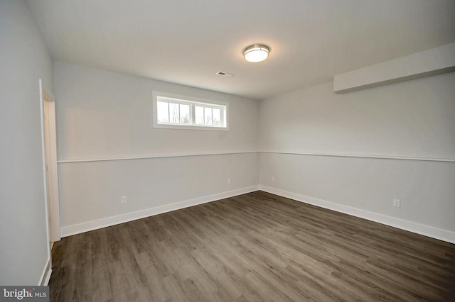 spare room featuring dark wood-type flooring