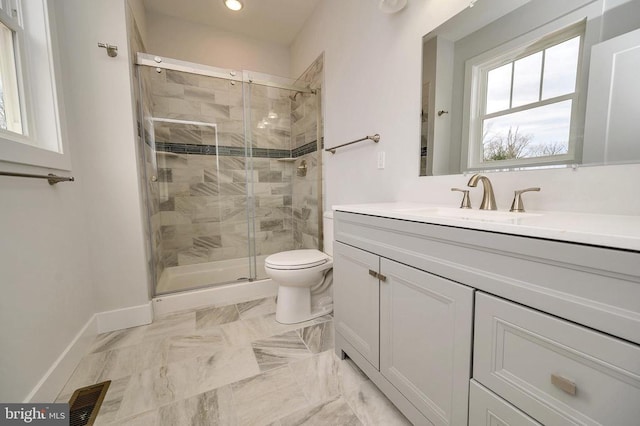 bathroom featuring tile floors, oversized vanity, an enclosed shower, and toilet