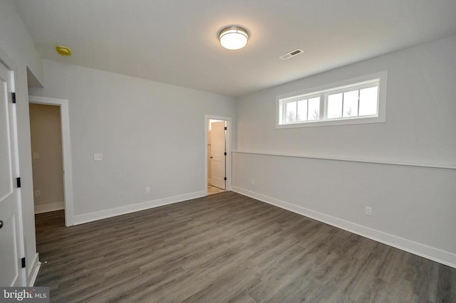 unfurnished room featuring dark hardwood / wood-style floors