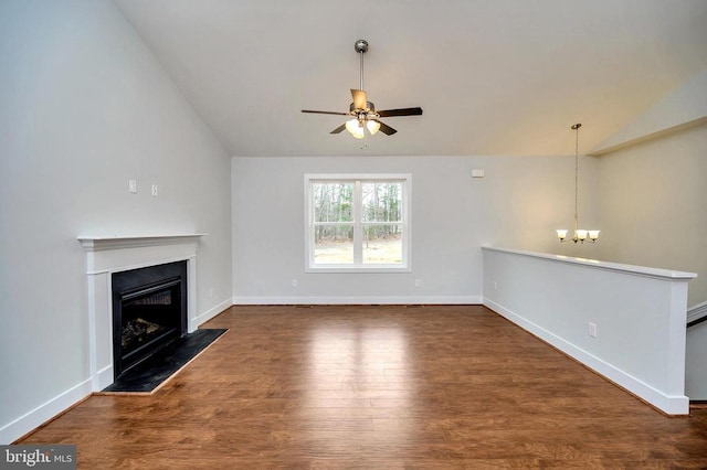 unfurnished living room featuring ceiling fan with notable chandelier, vaulted ceiling, and dark hardwood / wood-style flooring