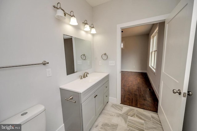 bathroom featuring tile floors, toilet, and oversized vanity