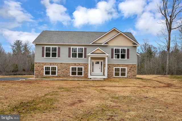 raised ranch with a front yard