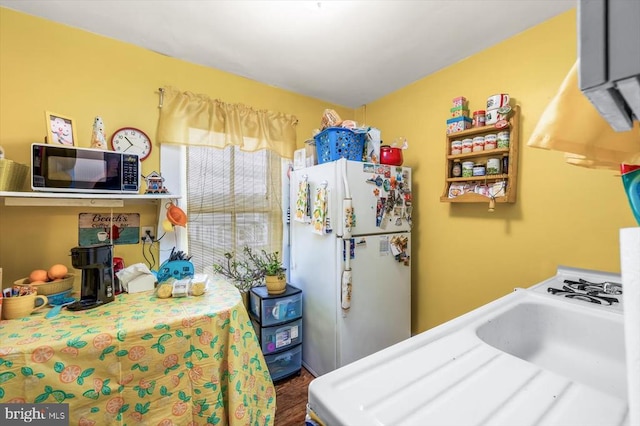 bedroom featuring wood-type flooring and white fridge