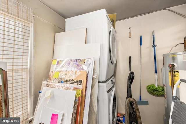 interior details with water heater and stacked washing maching and dryer