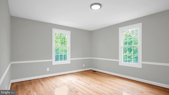 spare room featuring light hardwood / wood-style floors