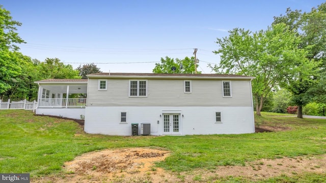 rear view of house with french doors, a lawn, and central AC unit