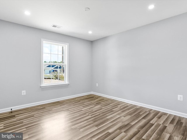 spare room with wood-type flooring