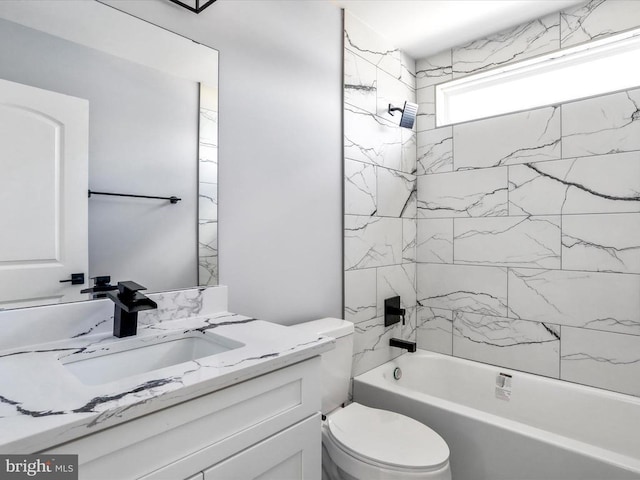 full bathroom with vanity, tiled shower / bath combo, and toilet