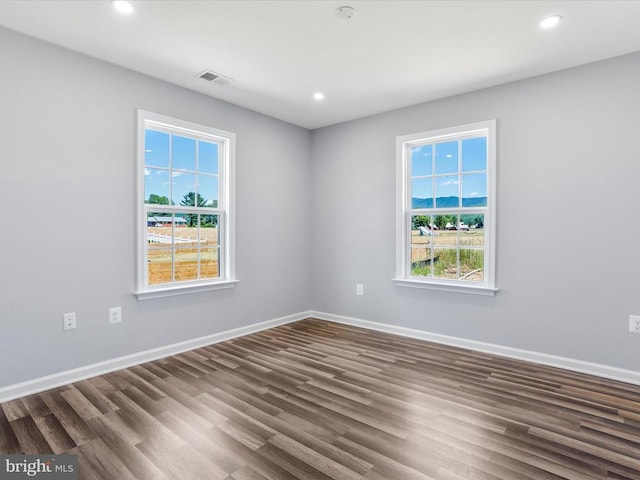 empty room featuring dark wood-type flooring