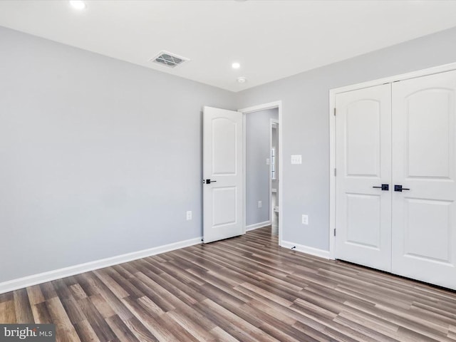 unfurnished bedroom featuring a closet and light hardwood / wood-style floors