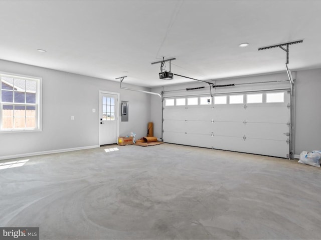 garage with electric panel and a garage door opener