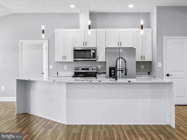 kitchen with white cabinetry, hanging light fixtures, stainless steel appliances, light stone counters, and an island with sink