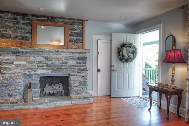 entrance foyer featuring a fireplace and hardwood / wood-style floors