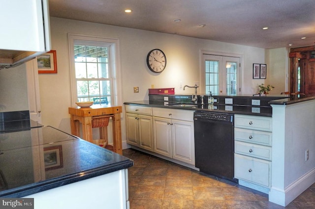 kitchen with white cabinets, sink, kitchen peninsula, and black dishwasher