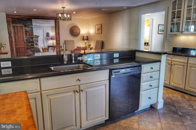 kitchen featuring sink, dark tile patterned floors, decorative light fixtures, and black dishwasher