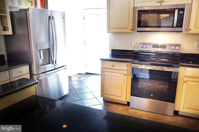 kitchen with tile patterned flooring and stainless steel appliances