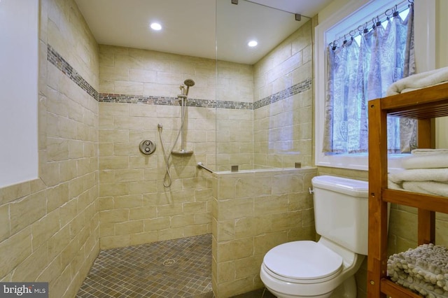 bathroom featuring toilet and tiled shower