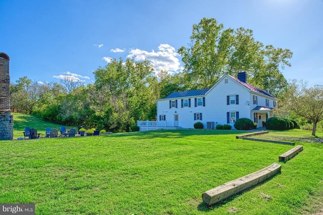 rear view of house with a yard