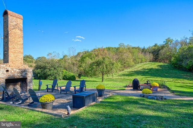 surrounding community with a lawn and a patio