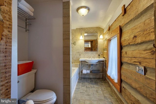 bathroom featuring decorative backsplash, sink, and toilet