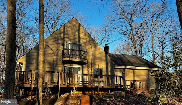 rear view of property featuring a balcony