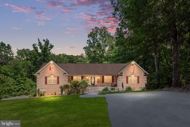 ranch-style house with a lawn