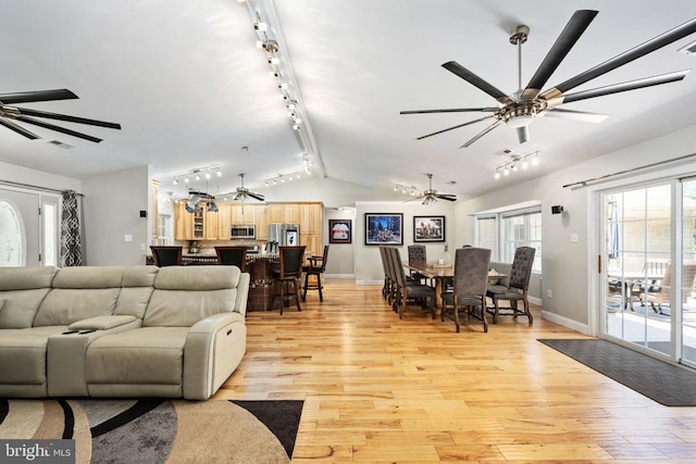 living room featuring light hardwood / wood-style floors and vaulted ceiling