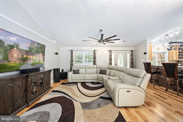 living room featuring light hardwood / wood-style flooring, ceiling fan, and lofted ceiling