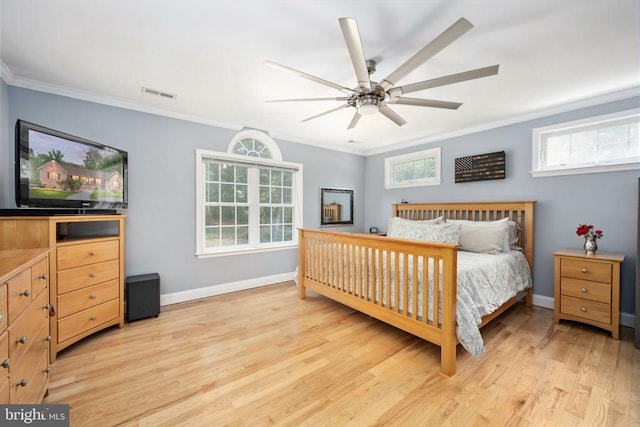 bedroom with ceiling fan, light hardwood / wood-style floors, crown molding, and multiple windows