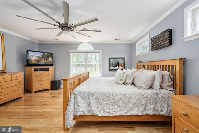 bedroom with light hardwood / wood-style floors, ceiling fan, and ornamental molding