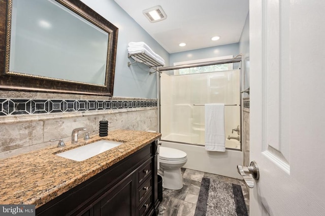 full bathroom with toilet, vanity, and combined bath / shower with glass door