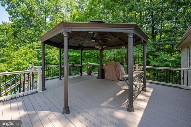 wooden terrace with a gazebo and ceiling fan