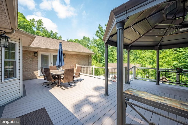 wooden terrace with a gazebo and french doors