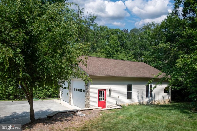 exterior space featuring a garage and a front yard