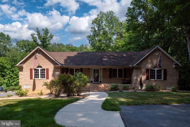 ranch-style home featuring a front yard