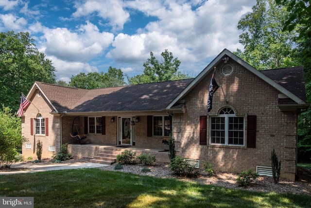 ranch-style house featuring a front yard and covered porch