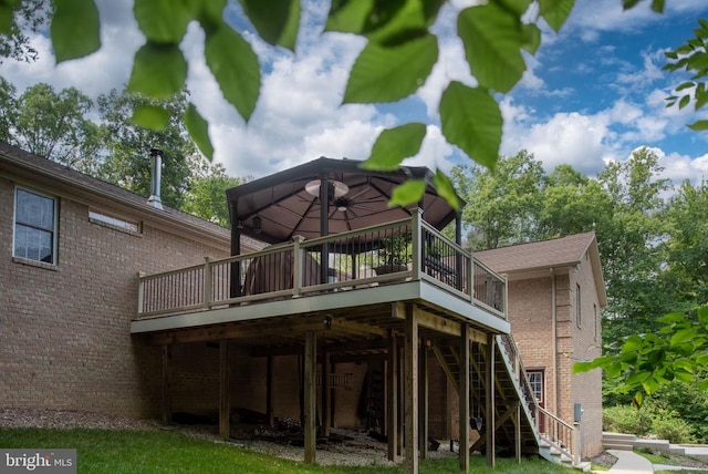 rear view of property with a gazebo and a wooden deck