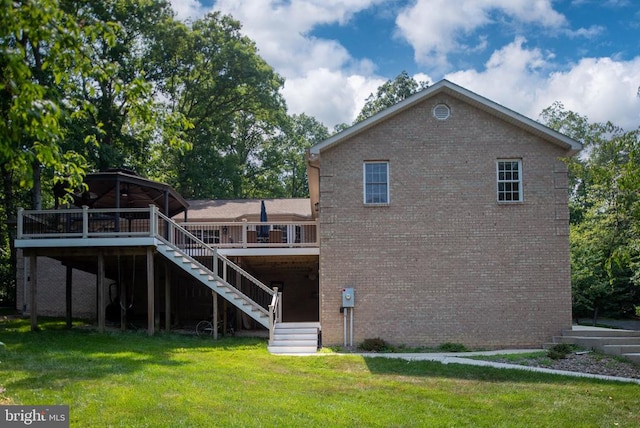 back of property with a deck and a lawn