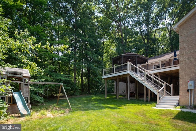 view of yard with a playground and a deck