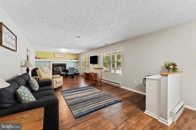 living room with wood-type flooring, a textured ceiling, and a baseboard heating unit