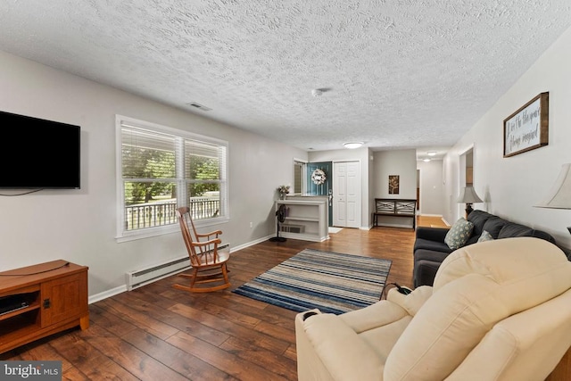 living room featuring a textured ceiling, baseboard heating, and wood-type flooring