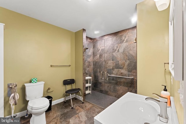 bathroom with walk in shower, tile patterned floors, toilet, and sink