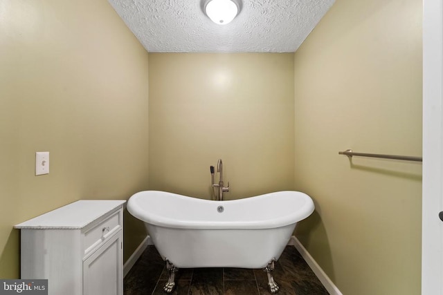 bathroom with tile patterned floors and a textured ceiling