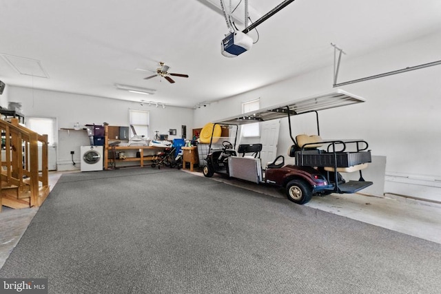 garage with a garage door opener, washer / dryer, and ceiling fan