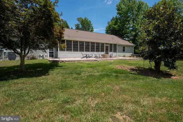 rear view of property with a lawn