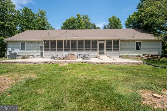 back of house with a patio and a lawn