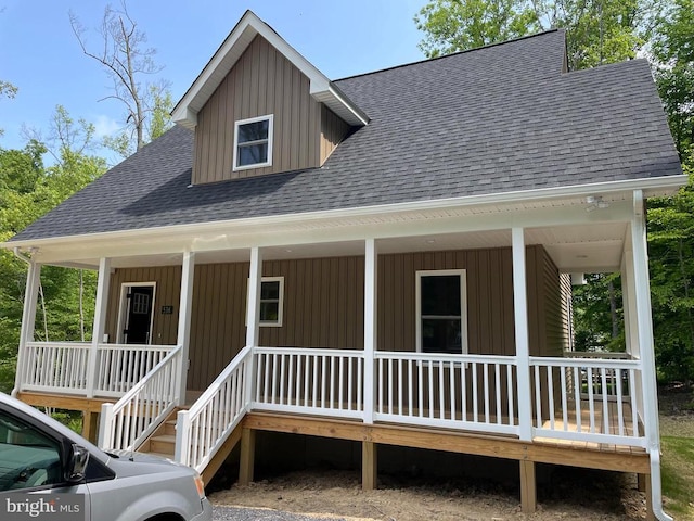 rear view of house featuring covered porch