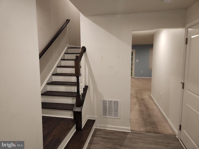 stairway featuring hardwood / wood-style flooring