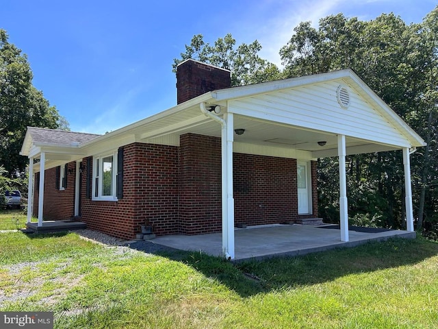 back of property featuring a yard